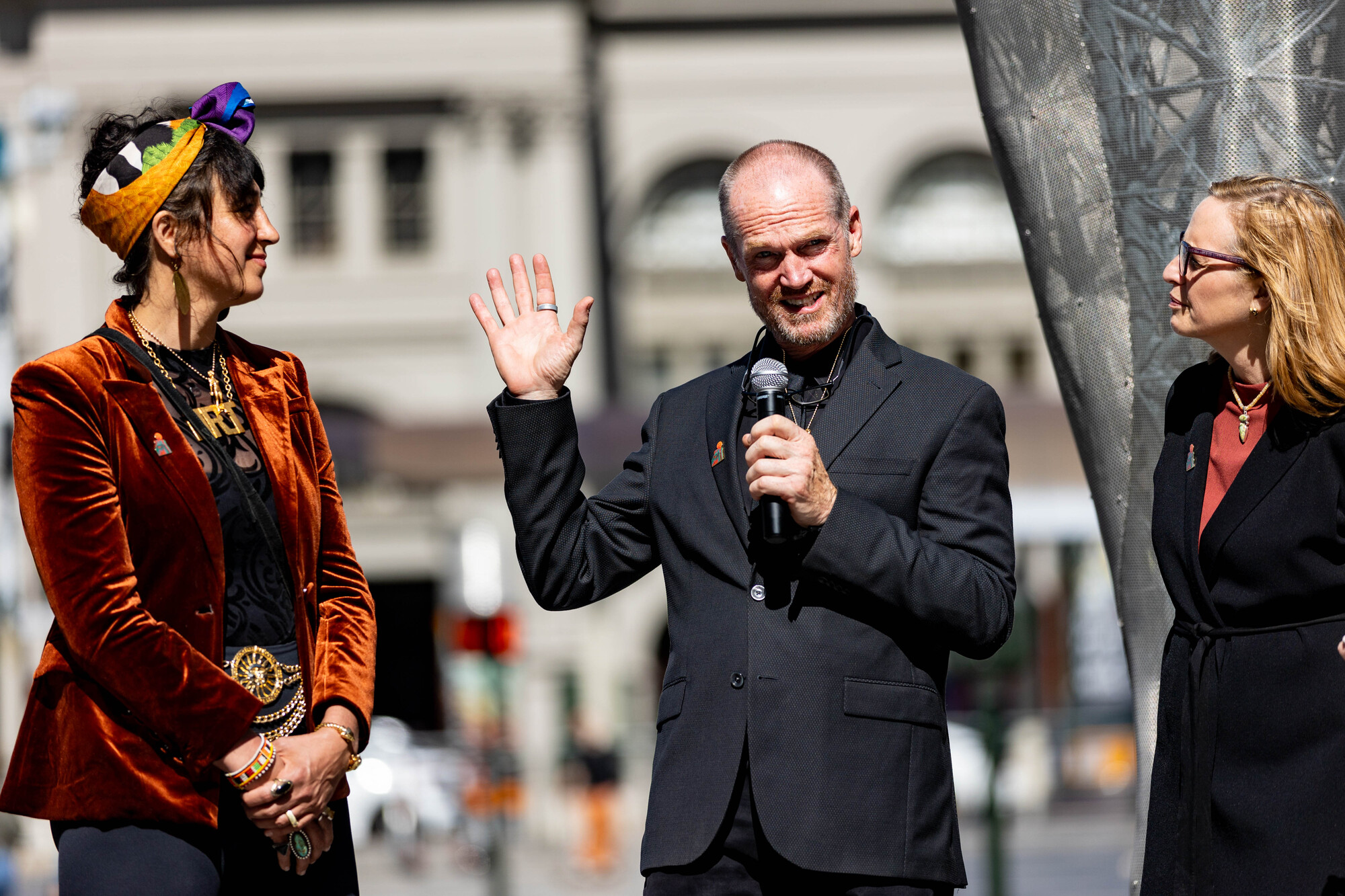 woman stands next to man with mic