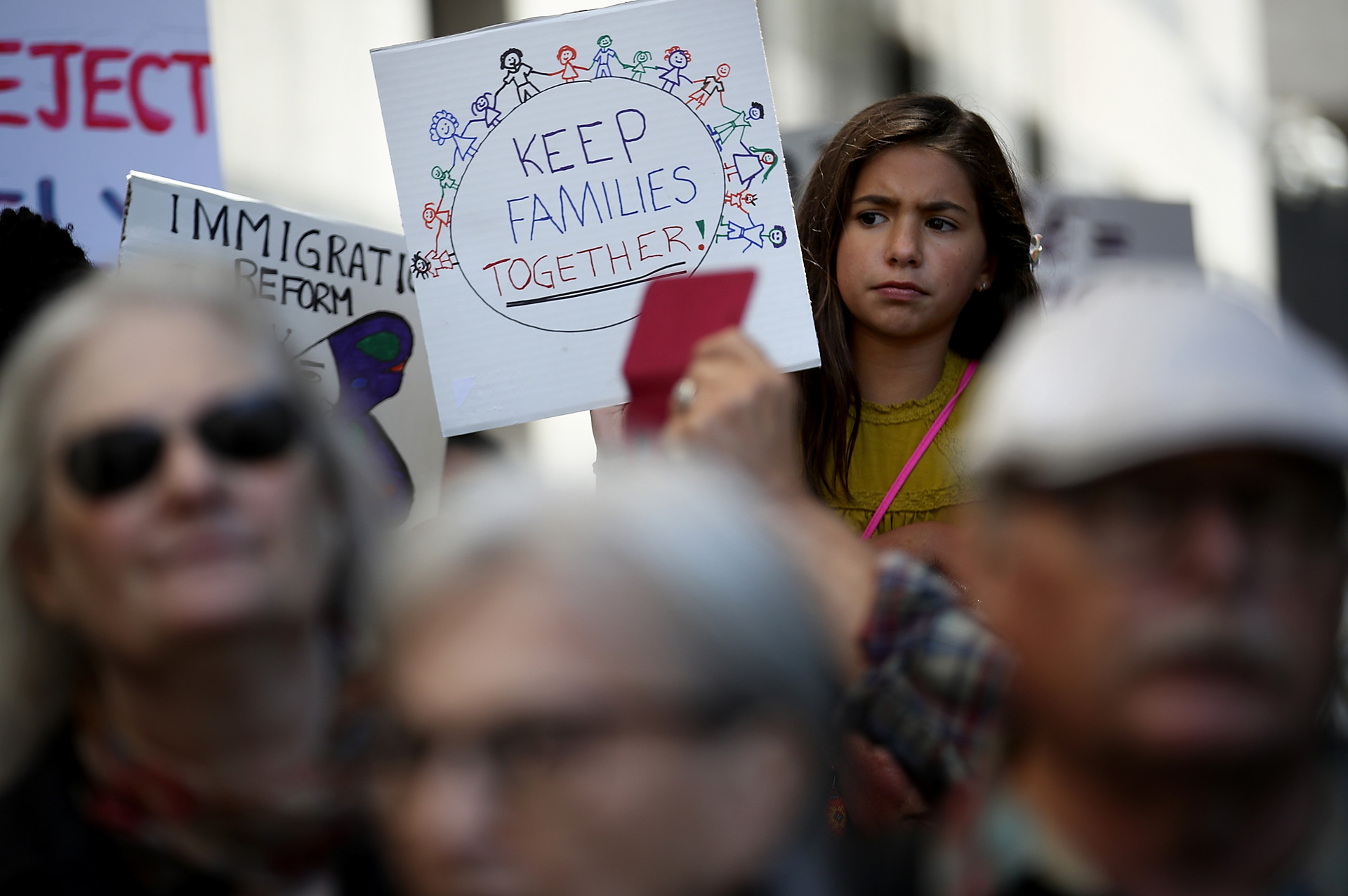 A young girl holds a sign during a demonstration outside of the San Francisco office of the Immigration and Customs Enforcement (ICE) on June 19, 2018 in San Francisco over the Trump administration family separation policy.